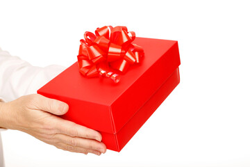 Close-up of female hands holding a present red box giving it to someone
