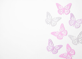 Fototapeta na wymiar Pastel Pink Butterflies on a White Background. Simple Modern Composition with Paper Cut Butterfies ideal for Banner, Card, Greetings. Top-Down View. No text.