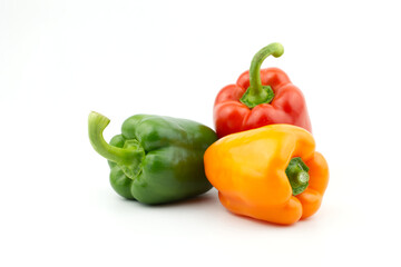 A group of pepper (capsicum), fresh juicy bell organic sweet red, green and yellow or orange peppers isolated on white background.  collection of three paprika whole. One of dem not have stem