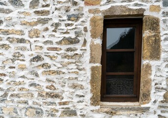 Old wooden window.Stone wall
