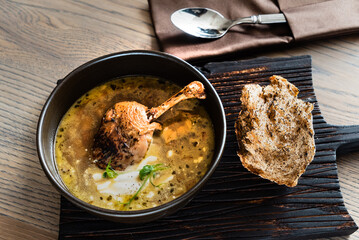 soup with duck on wooden board