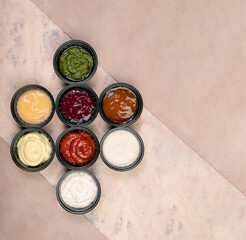 a group of sauces on a paper background with texture