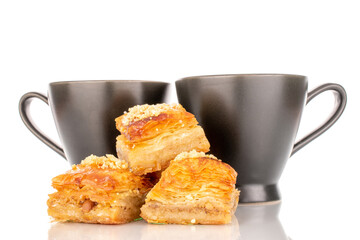 Sweet baklava classic with ceramic dishes, macro, isolated on a white background.