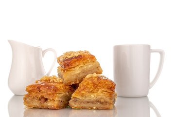 Sweet baklava classic with ceramic dishes, macro, isolated on a white background.