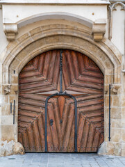 Old wooden gate with star pattern, ancient stone arch and closed massive door, Bratislava old town