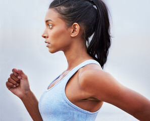 Determined to win this race. Shot of a young woman jogging.
