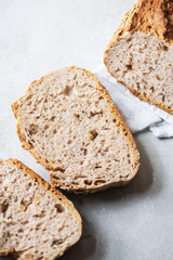 Slices of whole grain bread on a gray background. Close up.