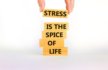 Stress spice of life symbol. Concept words Stress is the spice of life on wooden blocks. Businessman hand. Beautiful white background. Business motivational stress spice of life concept. Copy space.