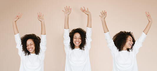 Obraz premium Group Young african american women over isolated background celebrating mad and crazy for success with arms raised and closed eyes screaming excited. Winner concept