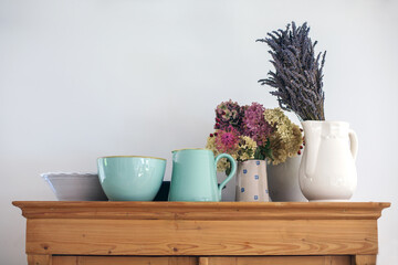 group of vintage porcelain bowls with flowers on wooden commode