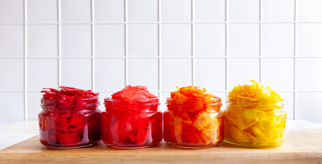 Close-up of multi-colored organic Cabbage in glass jars, fermented with various seasonings and...