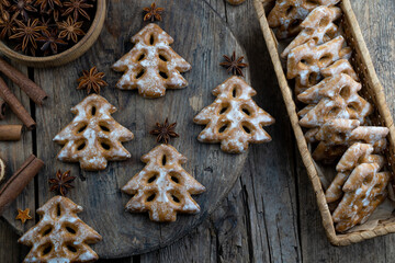 Christmas tree cookies on wooden background. New Year's food. Anise star. Festive baked goods. Gingerbread on the table.Icing sugar sweetness taste season.