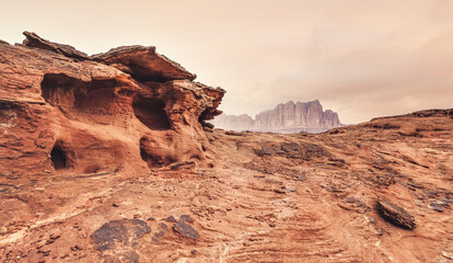 Red sandstone rocks formations in Wadi Rum (also known as Valley of the Moon) desert, Jordan, scene...