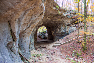 Weathered stone arch cave in the forest