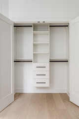 Fototapeta na wymiar Custom Closet Organization. Contemporary closet design with shelves, drawers and rods.
