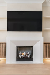 Contemporary Living Room Fireplace and Mounted TV. Lit gas fireplace with blank screen TV mounted above.