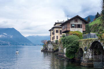 Fototapeta na wymiar Beautiful view of the lake Como in the Lombardy region of Italy on a cloudy day. Travel Italy.