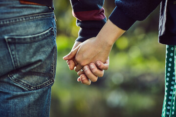 Yours is the only hand I ever want to hold. Cropped shot of an affectionate couple holding hands outdoors.