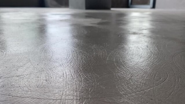 The process of priming the floor with a roller