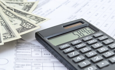 Calculator, money and different bills close-up. Business, household and home budget concept