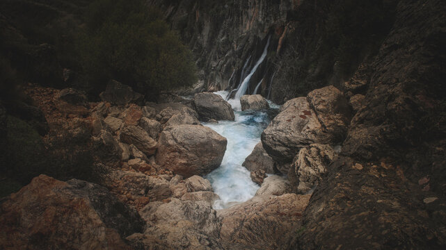 Birth of the Castril river in Granada, Spain. Its transparent and bluish waters run between rocks in the shadows. Special to highlight ecology and nature