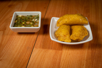 Colombian empanada with spicy sauce