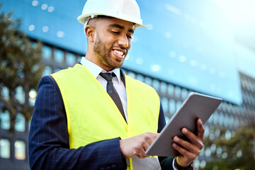 This building is going to be magnificent. Shot of a young businessman on a construction site using...