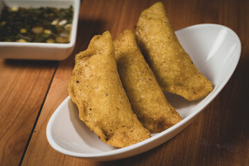 Colombian empanada with spicy sauce