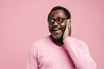 Black bearded man in eyeglasses expressing surprise at camera