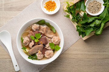 Boiled Pork Blood Soup with gourd leaves,Clear soup asian style food mixed minced pork balls,Pork blood cubes and liver in with bowl,Healthy and Rich in iron and protein