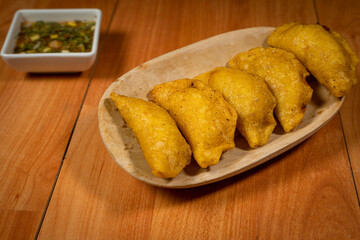 Delicious traditional Colombian empanadas with spicy sauce