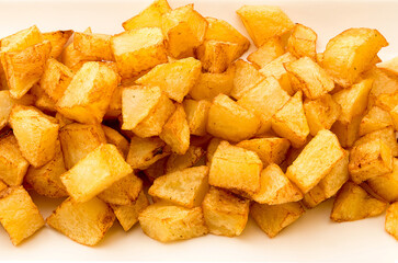 Typical Spanish food, close up view of a portion of potatoes. Horizontal view of cooked and diced potatoes.