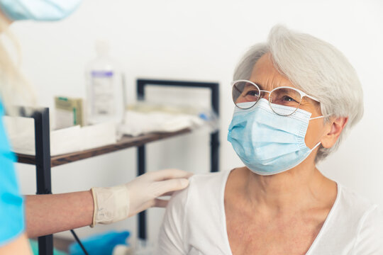 senior woman talking to her doctor and smiling medium closeup hospital healthcare concept . High quality photo