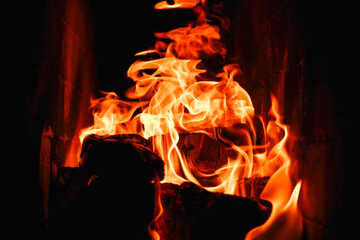 Burning firewood and coals in a stone stove. Brick oven on wood. Long tongues of flame of burning fire