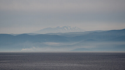 Panorama of beautiful simplistic and minimal natural scenery of Greece combining sea, land, mountains and sky