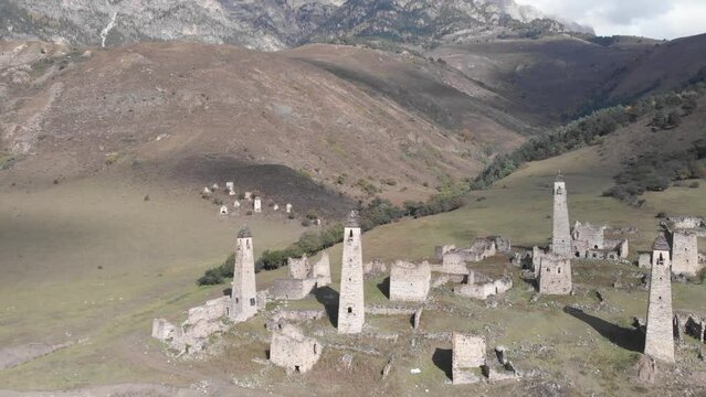 Flying between ancient towers of Egikal complex out of the river. Republic of Ingushetia. Caucasus mountains, Russia.