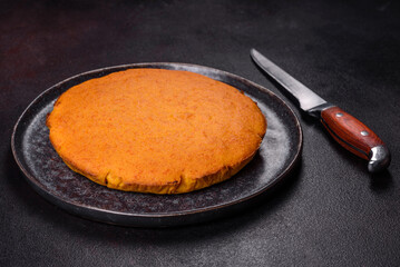 Pumpkin pie, tart made for Thanksgiving day with whipped cream on a black plate