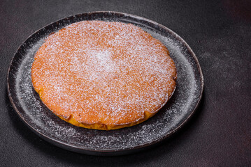 Pumpkin pie, tart made for Thanksgiving day with whipped cream on a black plate