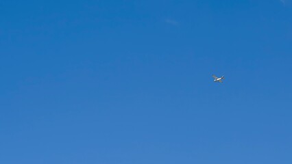 Small recreational plane, ideal for flight practice flying over a blue sky on a clear day