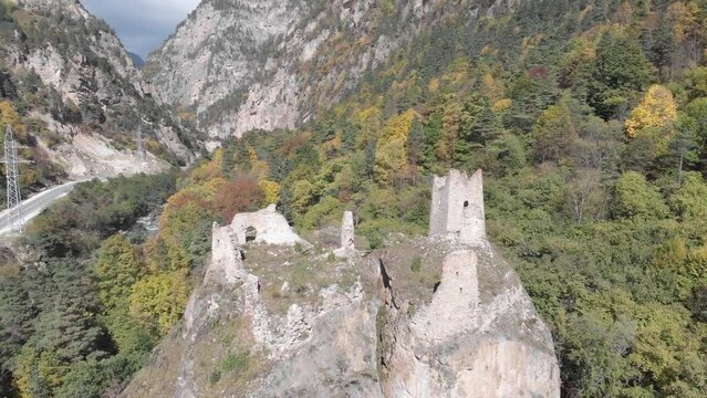 Flying between ancient towers of Egikal complex out of the river. Republic of Ingushetia. Caucasus mountains, Russia.