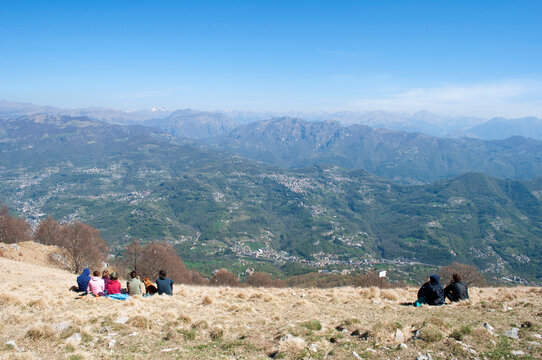 Hikers Relaxing on Monte Linzone Peak. Italy