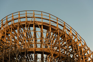 Curve of a large wooden roller coaster.