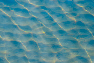 Light reflections of sun through the waves in shallow waters.