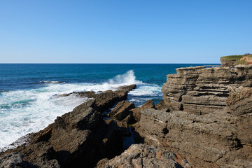 Fototapeta na wymiar Cliffs with deep blue sea and clear skies