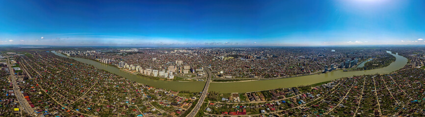 Fototapeta premium Large aerial panorama of the embankment near the Turgenev bridge in the city of Krasnodar on a sunny April day