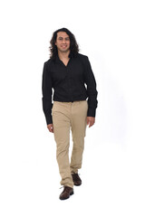front view of a man with long hair walking and looking at camera and smiling on white background
