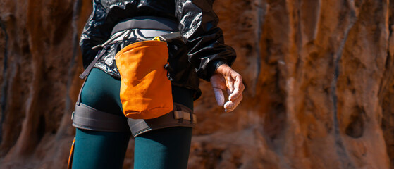 Girl climbs with magnesium powder, hand closeup.