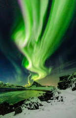 strong aurora borealis over the night sky