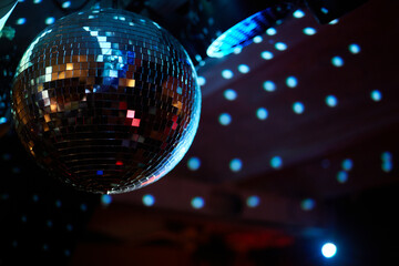 Colorful disco mirror ball lights night club background.