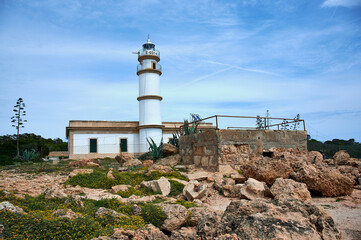 Lighthouse at Cap de Ses Salines on Majorca island, Spain Mediterranean Sea.